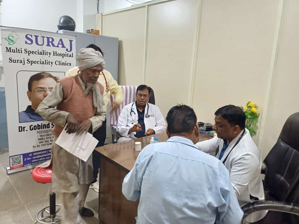 A doctor examining an elderly patient at a free health camp