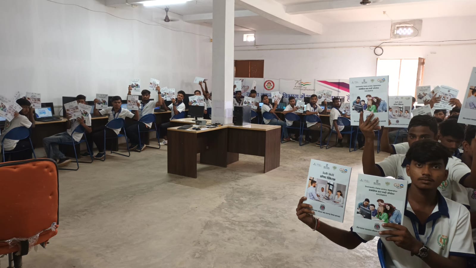 Students in a skill-centre computer lab holding their course books